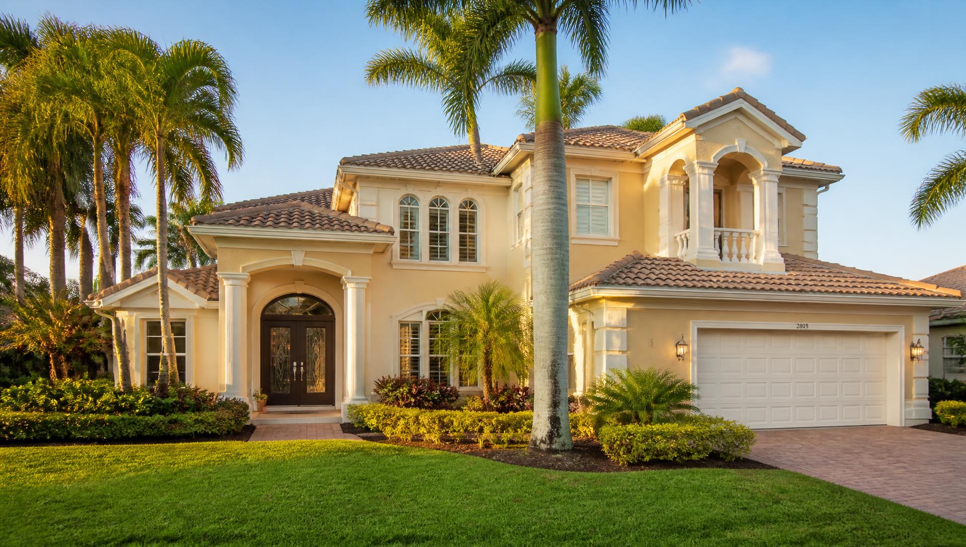Freshly painted Florida home with cream stucco walls and crisp white trim